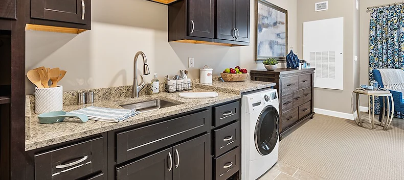 Westhill Newnan Crossing senior living community offering assisted living and memory care in Newnan, GA, apartment kitchen and laundry