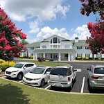 Charter Senior Living of Augusta Gardens senior living community offering assisted living and memory care in Augusta, GA, front exterior and resident parking area