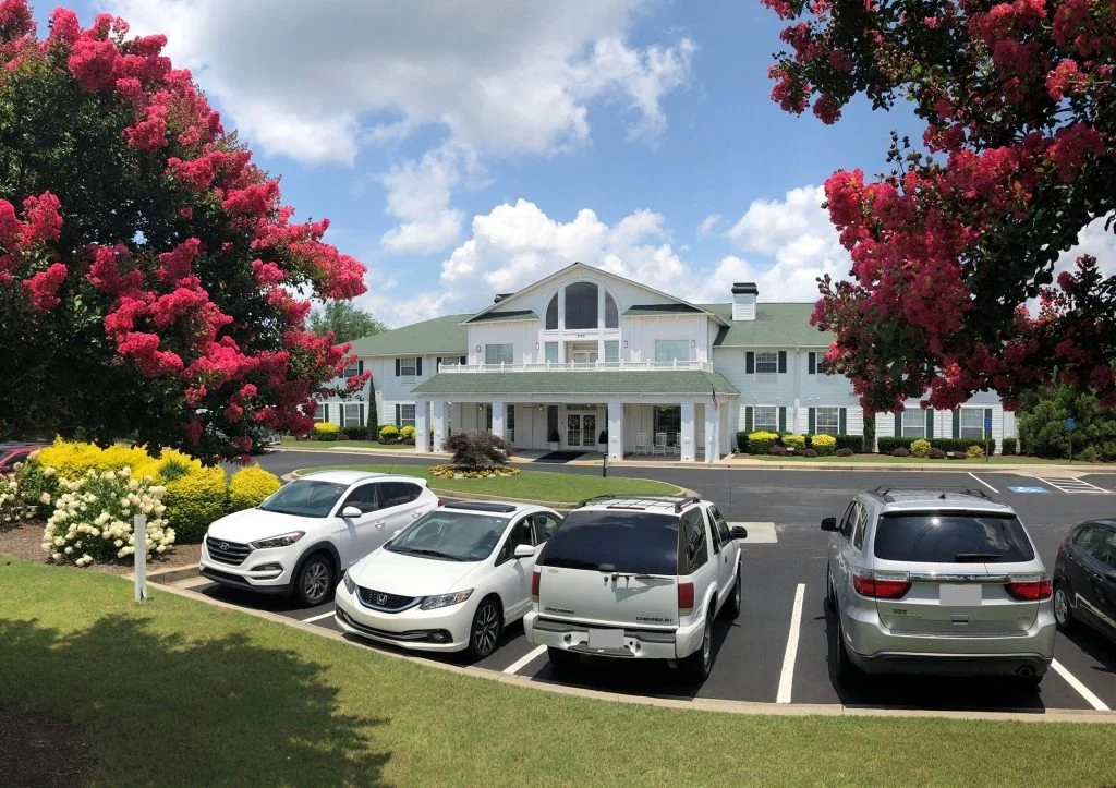 Charter Senior Living of Augusta Gardens senior living community offering assisted living and memory care in Augusta, GA, front exterior and resident parking area
