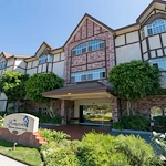 Lexington Assisted Living senior living community offering independent living, assisted living, and memory care in Ventura, CA, front exterior and entrance with large glass doors