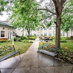 Westlake Woods by New Perspective senior living community offering assisted living in Erie, PA, outdoor space with benches and a walking path