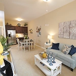 Allegro Richmond Heights senior living offering assisted living, memory care, and respite care in Richmond Heights, MO, apartment with an open layout featuring the kitchen area and living room
