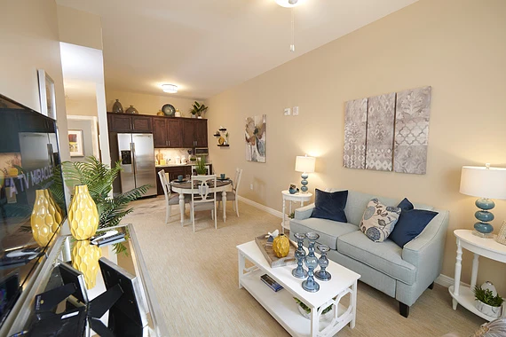 Allegro Richmond Heights senior living offering assisted living, memory care, and respite care in Richmond Heights, MO, apartment with an open layout featuring the kitchen area and living room