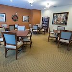 Brookdale Franklin Independent Living in Franklin, TN, community room with tables for games and a full bookshelf