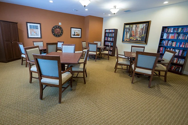 Brookdale Franklin Independent Living in Franklin, TN, community room with tables for games and a full bookshelf