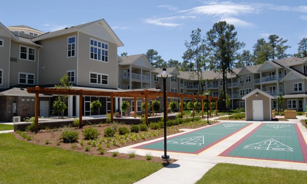 Summerville Estates Gracious Retirement Living Hawthorn Senior Independent Living in Summerville, South Carolina rear exterior gazebo shuffleboard area