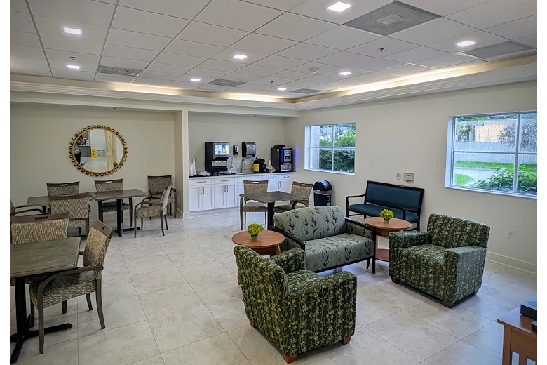 Lenox on the Lake senior living community offering assisted living and memory care in Lauderhill, FL, community dining and socializing area with tables and chairs