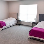 Legato Living Residential Memory Care at Heartland Hills senior living community offering assisted living, memory care, adult day services, and respite care in Bellevue, NE, shared suite with two beds and two nightstands