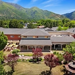 Avamere at Mountain Ridge senior living community offering assisted living, memory care, and respite care in South Ogden, UT, community exterior view with beautiful landscaping and mountains in view