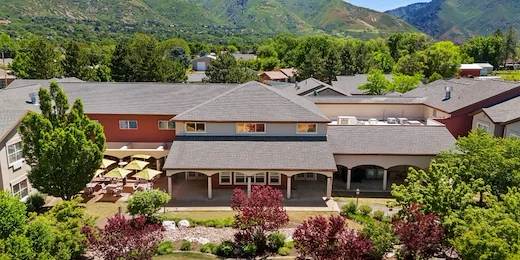 Avamere at Mountain Ridge senior living community offering assisted living, memory care, and respite care in South Ogden, UT, community exterior view with beautiful landscaping and mountains in view
