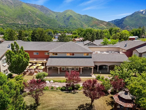 Avamere at Mountain Ridge senior living community offering assisted living, memory care, and respite care in South Ogden, UT, community exterior view with beautiful landscaping and mountains in view
