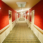 Wesley Manor Assisted Living Community offering assisted living and continuing care retirement community (CCRC) services in Louisville, KY, hallway with red wallpaper