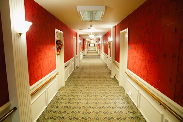 Wesley Manor Assisted Living Community offering assisted living and continuing care retirement community (CCRC) services in Louisville, KY, hallway with red wallpaper