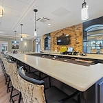 Brightmore of South Charlotte senior living community offering independent living, assisted living, and memory care in Charlotte, NC, bar area with countertop and barstool seating