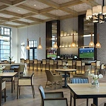 Wellington Bay with Lisbet Health Center senior living community offering independent living, assisted living, and memory care in Wellington, FL, restaurant-style dining room with bar and TVs