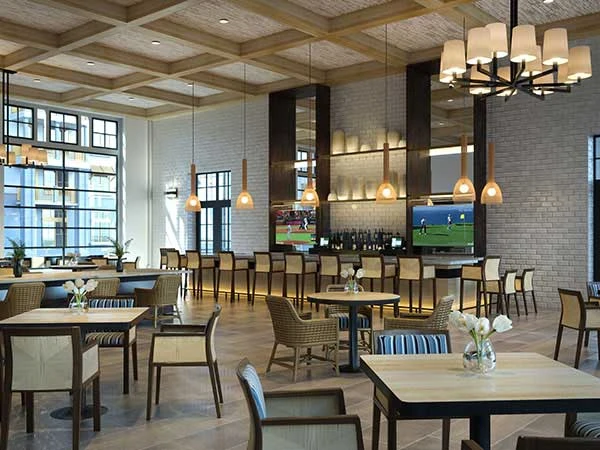 Wellington Bay with Lisbet Health Center senior living community offering independent living, assisted living, and memory care in Wellington, FL, restaurant-style dining room with bar and TVs
