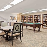 Bear Hollow Estates Hawthorn Senior Independent Living in Rancho Cordova, California, game room and libray featuring a pool table and large bookshelves