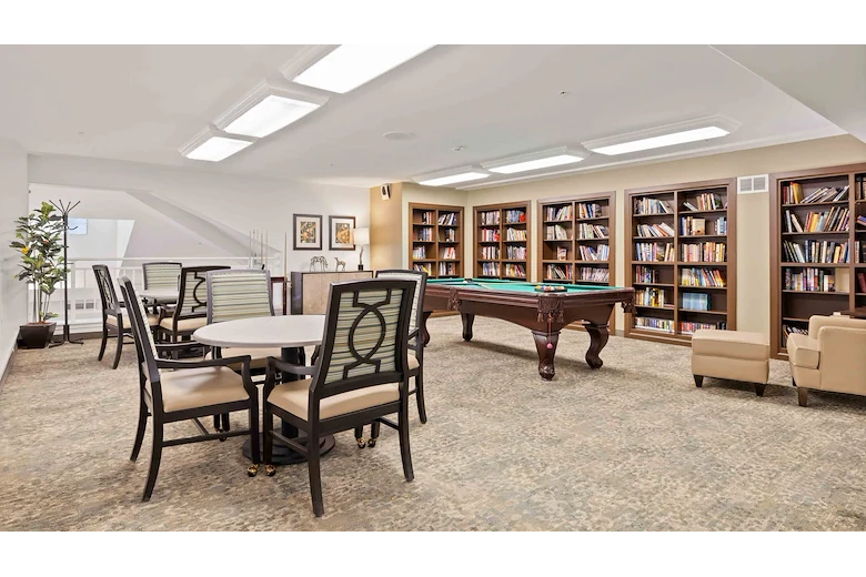 Bear Hollow Estates Hawthorn Senior Independent Living in Rancho Cordova, California, game room and libray featuring a pool table and large bookshelves