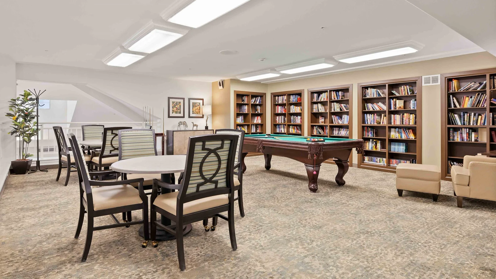 Bear Hollow Estates Hawthorn Senior Independent Living in Rancho Cordova, California, game room and libray featuring a pool table and large bookshelves