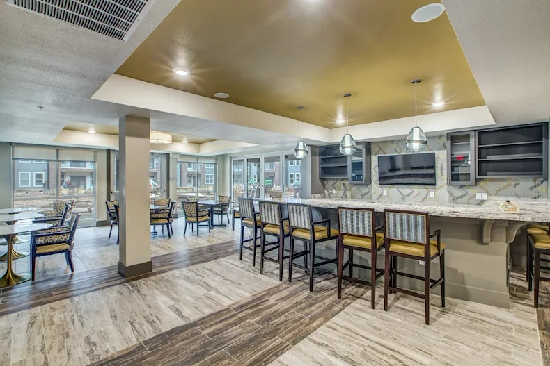 Watermere at Round Rock senior living community offering active adult living and independent living in Round Rock, TX, community dining area featuring bar stool seating at a countertop
