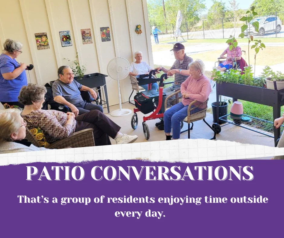 Residents and team members enjoying time outdoors on our covered porch.