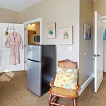 Refrigerator and small chair in one of the bedrooms at Orchard Ridge 