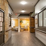 Well-lit hallway with comfortable seating area at Charter Senior Living of Hazel Crest in Hazel Crest, IL, providing a welcoming and accessible environment for assisted living and memory care residents.