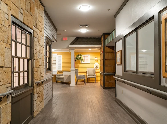 Well-lit hallway with comfortable seating area at Charter Senior Living of Hazel Crest in Hazel Crest, IL, providing a welcoming and accessible environment for assisted living and memory care residents.