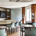 Allegro Tallahassee senior living offering independent living, assisted living, and respite care in Tallahassee, FL, social area featuring a bar and seating at tables for happy hours