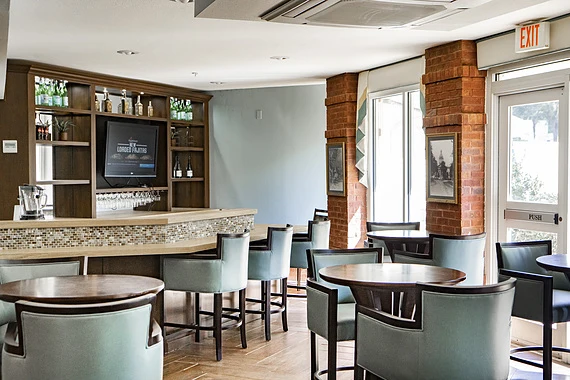 Allegro Tallahassee senior living offering independent living, assisted living, and respite care in Tallahassee, FL, social area featuring a bar and seating at tables for happy hours