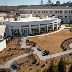 Westhill Macon senior living community offering assisted living and memory care in Macon, GA, outdoor area with a walking path and benches