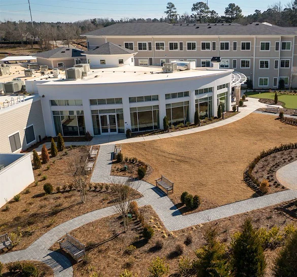 Westhill Macon senior living community offering assisted living and memory care in Macon, GA, outdoor area with a walking path and benches
