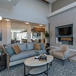 Acclaim at The Hill, senior living community offering active adult and independent living in Fredericksburg, VA, modern common sitting area by fireplace 