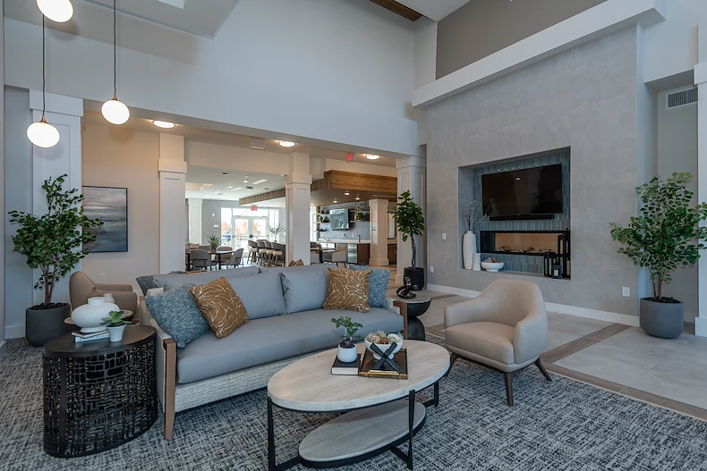 Acclaim at The Hill, senior living community offering active adult and independent living in Fredericksburg, VA, modern common sitting area by fireplace 