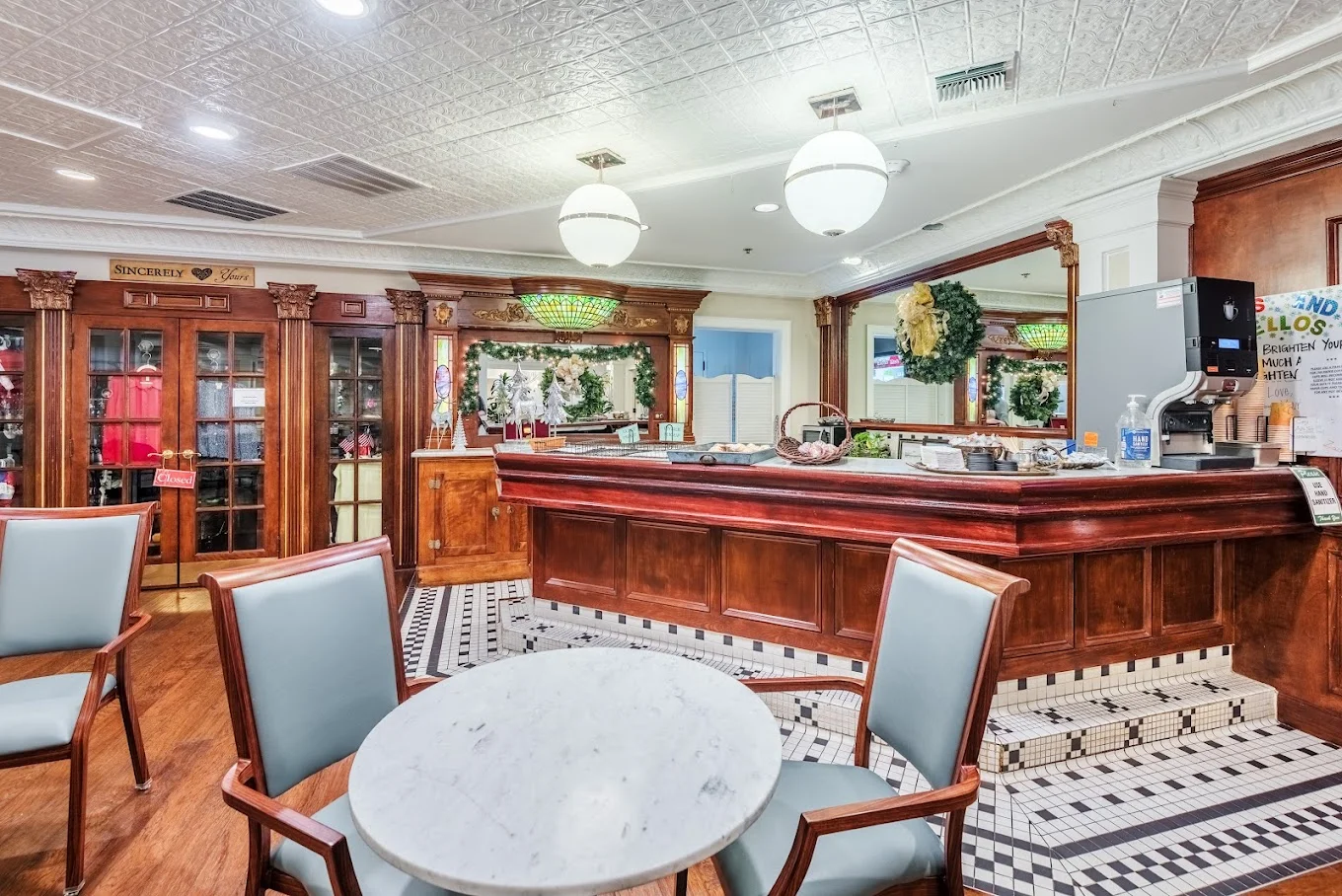 Independent living at Brightmore of Wilmington in Wilmington, NC, community room featuring a large bar with refreshments and a nearby table with two chairs