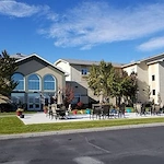 Avamere at Moses Lake senior living community offering independent living, assisted living, and respite care in Moses Lake, WA, outdoor seating area on a paved patio with chairs and tables