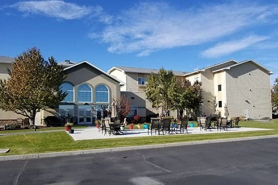 Avamere at Moses Lake senior living community offering independent living, assisted living, and respite care in Moses Lake, WA, outdoor seating area on a paved patio with chairs and tables