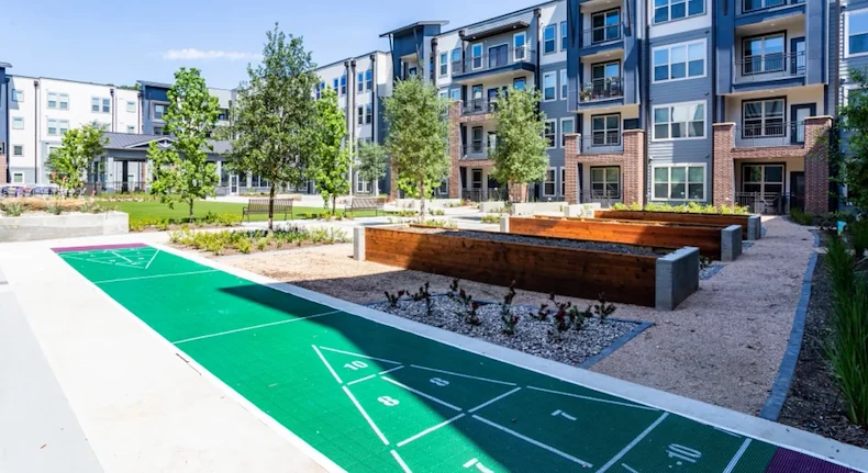 Watermere at Woodland Lakes senior living community offering active adult living and independent living in Conroe, TX, outdoor space with a walking path, activities, and garden beds