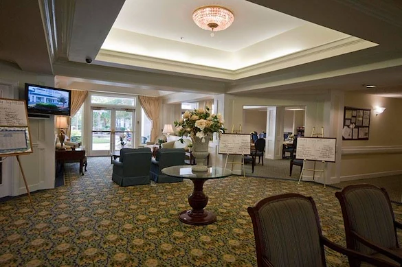 Charter Senior Living of Augusta Gardens senior living community offering assisted living and memory care in Augusta, GA, lobby with cozy seating and a view into the dining area