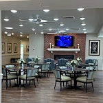 Faith Cottages Memory Care Basehor, KS, sitting area with tables by fireplace
