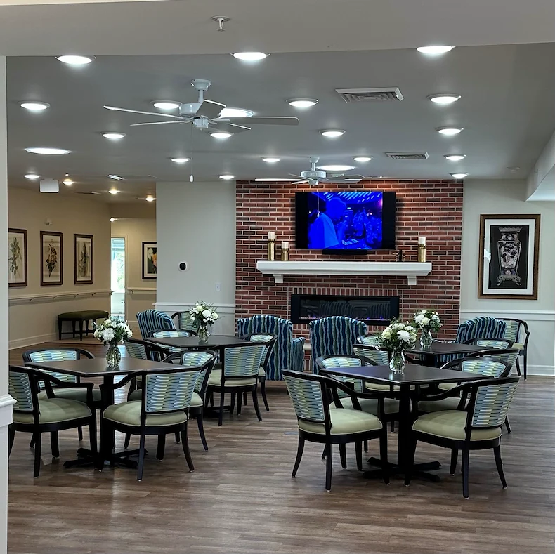 Faith Cottages Memory Care Basehor, KS, sitting area with tables by fireplace