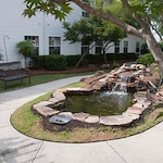 Charter Senior Living of Augusta Gardens senior living community offering assisted living and memory care in Augusta, GA, outdoor pond and walking path area