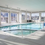 Watermere at Flower Mound senior living community offering active adult living and independent living in Flower Mound, TX, indoor pool with large garage doors that open to the outdoors