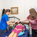Caregivers practice skills in our Center of Excellence, a training space designed as a realistic simulation of a client’s home. Training occurring here helps caregivers identify hazardous items, learn more about the safety of a client’s home, and demonstrate the proper use of durable medical equipment (DME), so caregivers can better assist with mobility, transfers, bathing, and toileting assistance. 