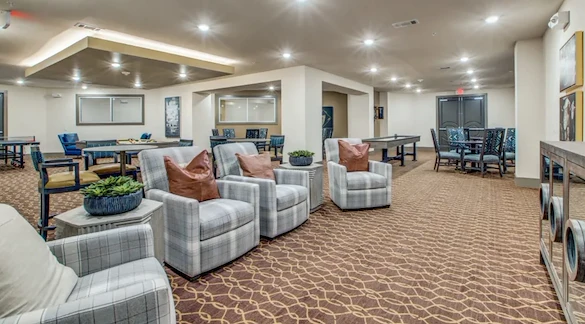 Watermere at Woodland Lakes senior living community offering active adult living and independent living in Conroe, TX, lounging area in the activities/game room