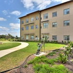 Élan Westpointe exterior with landscaping and paved walking path