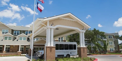 The Oaks Gracious Retirement Living Hawthorn Senior Independent Living in Georgetown, Texas front exterior with transportation bus
