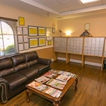 Lexington Assisted Living senior living community offering independent living, assisted living, and memory care in Ventura, CA, mail room with personal mailboxes and a couch