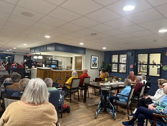 Residents of the Waters of Oak Creek enjoy music therapy brought to them by the South Milwaukee Municipal Band