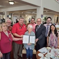 Alexis Estates Gracious Retirement Living Hawthorn Senior Living community in Allen, TX resident celebrating